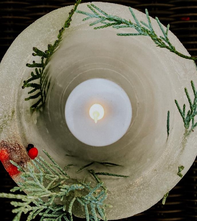 A candle sits inside an ice lantern A candle sits inside an ice lantern
