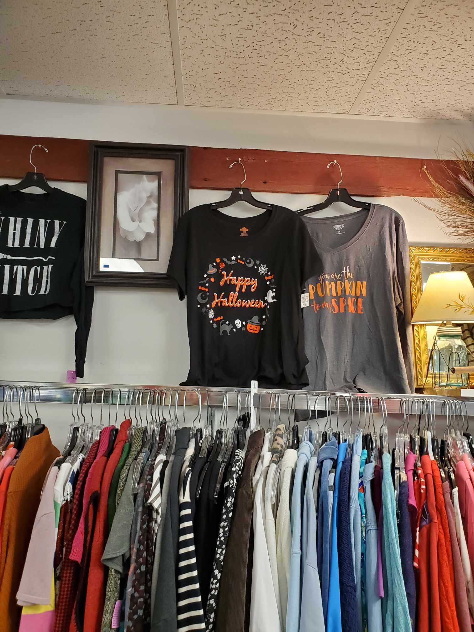 Halloween shirts above a larger shirt rack for resale