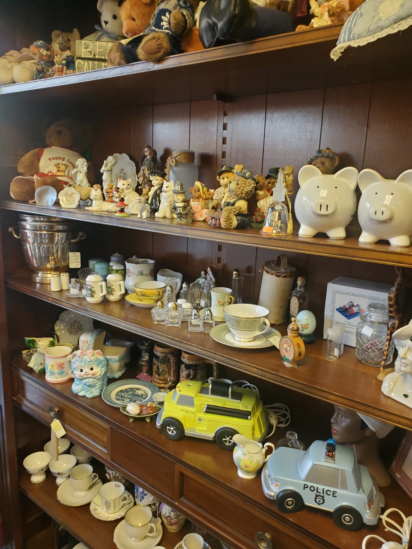 A shelf full of various figurines for home decoration
