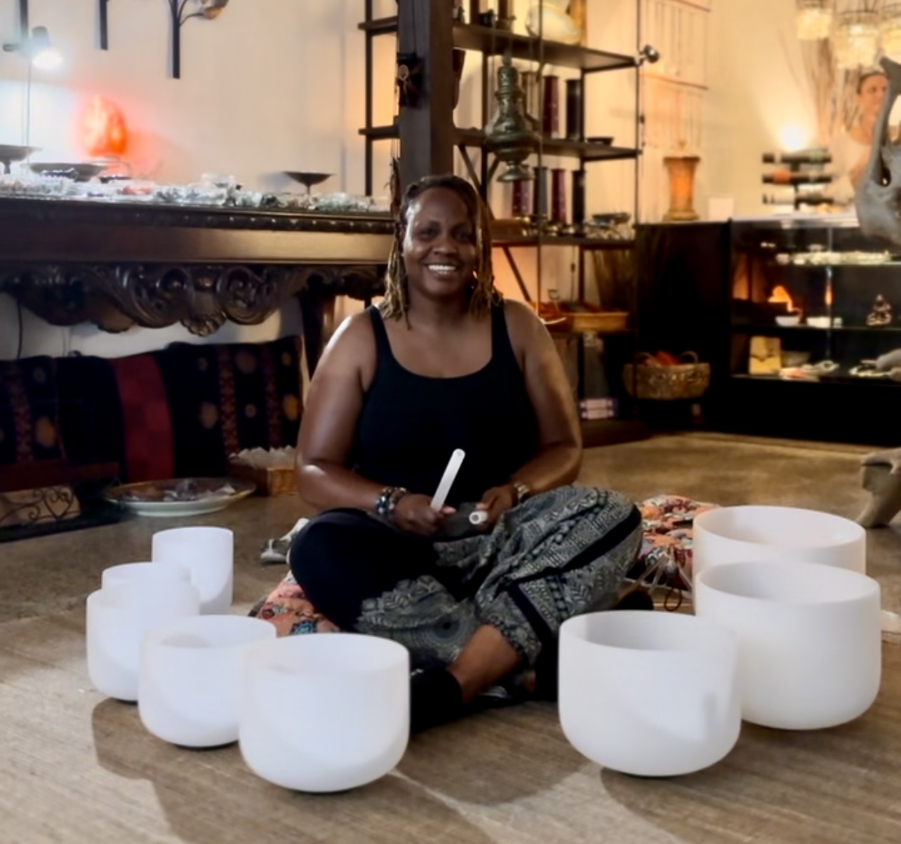 Dr. Asia sitting with her crystal singing bowls