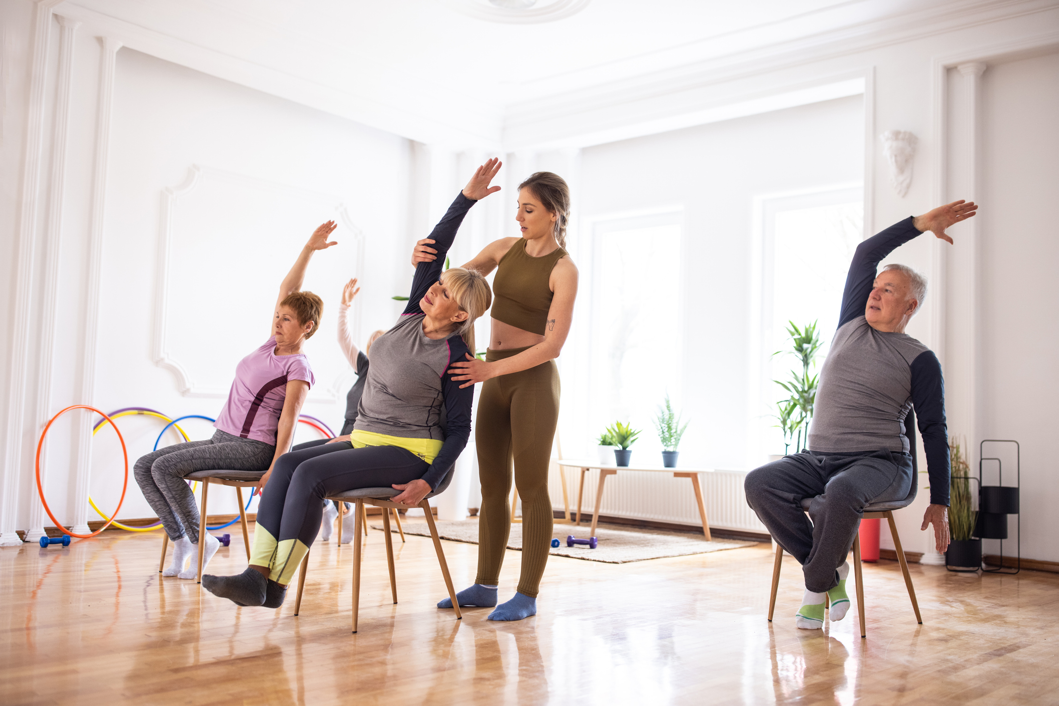 Integrated care rehabilitation class with seniors doing therapeutic exercises to improve mobility and support return to work