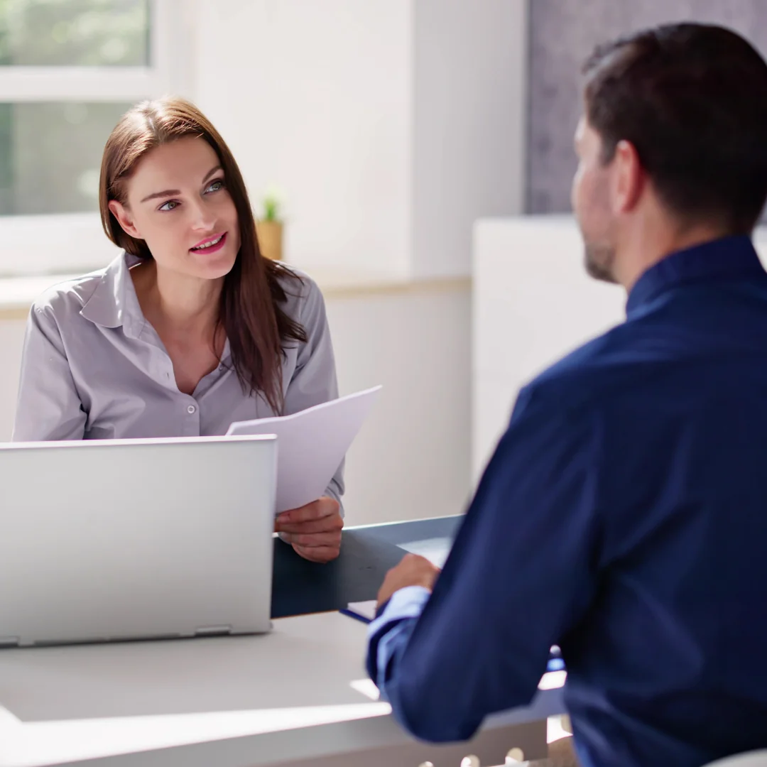 Financial services professional working on a laptop at a modern desk