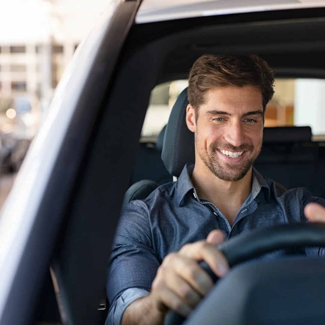 Automotive customer smiling while test driving a car