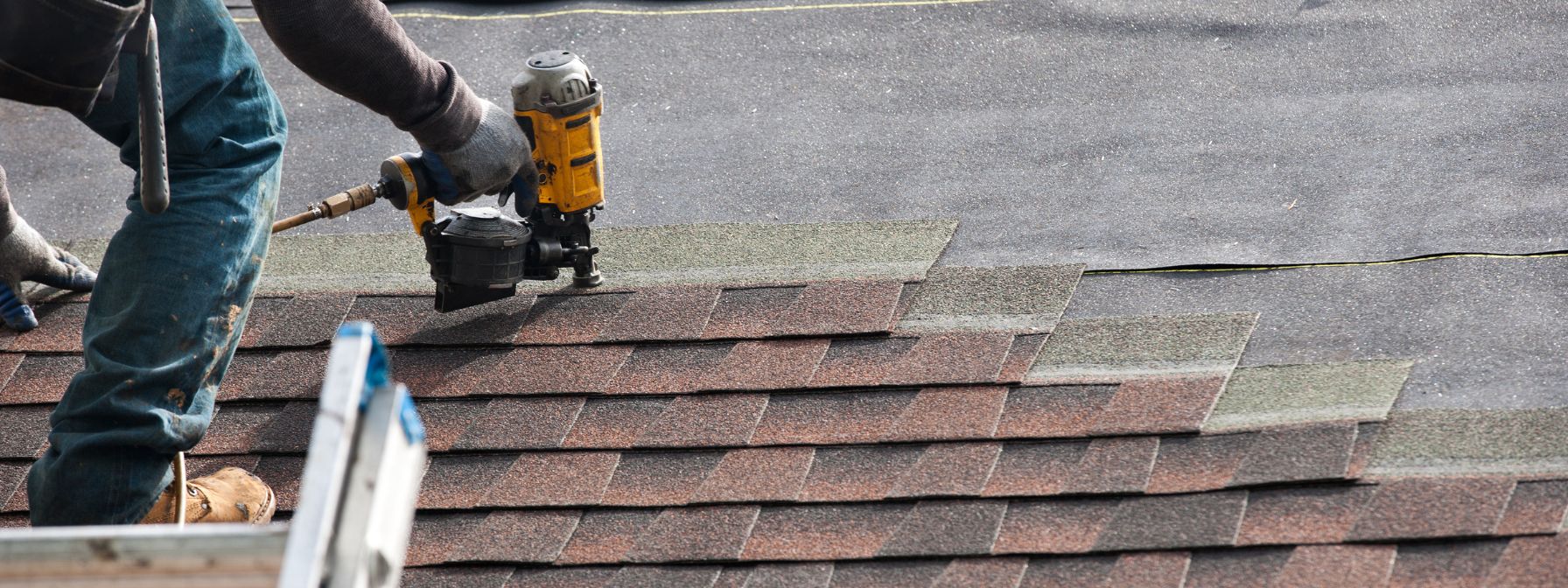 A roofer uses a nail gun to secure asphalt shingles during a roof repair—highlighting the urgency and precision involved in emergency roofing services discussed by CHS Roofing and Siding. A roofer uses a nail gun to secure asphalt shingles during a roof repair—highlighting the urgency and precision involved in emergency roofing services discussed by CHS Roofing and Siding.