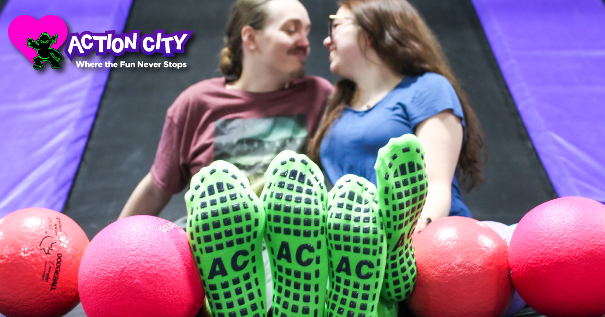 A couple sitting together in Action City's trampoline park