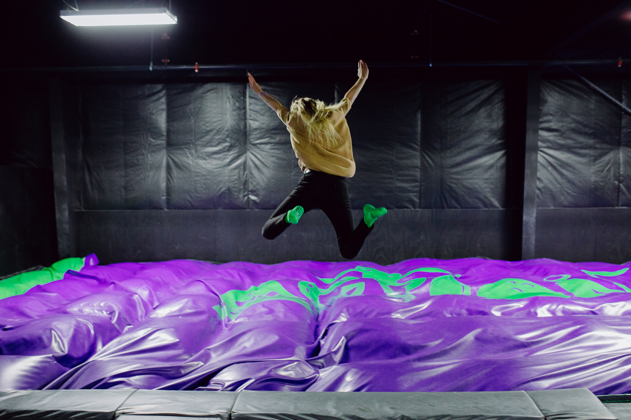 Woman jumping at the stunt jump court in Action City's Trampoline Park