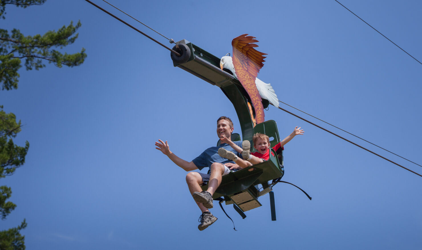 Guests riding the soaring eagle zipline at Action City