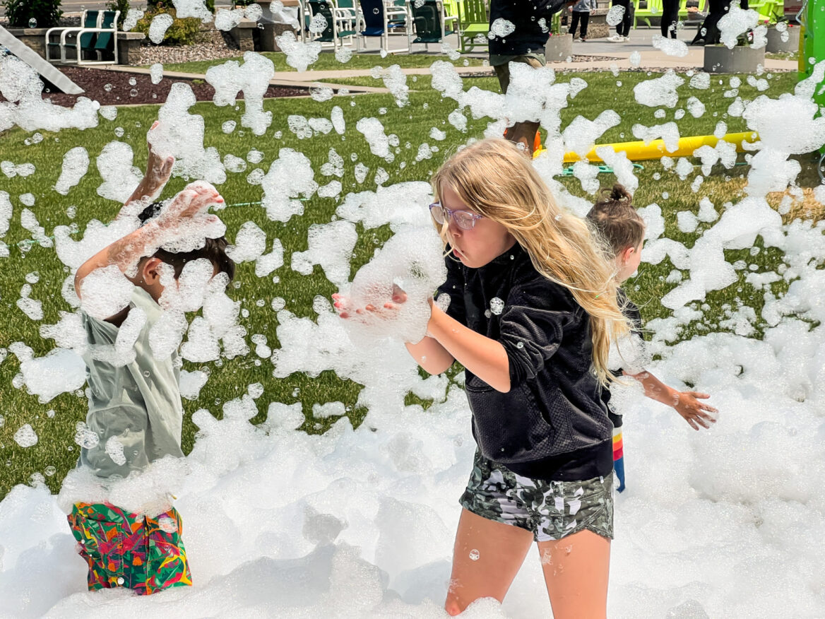 Kids playing in foam in the Chaos Water Park backyard