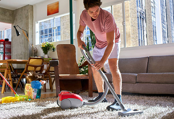 Man Vacuuming a shag rug 