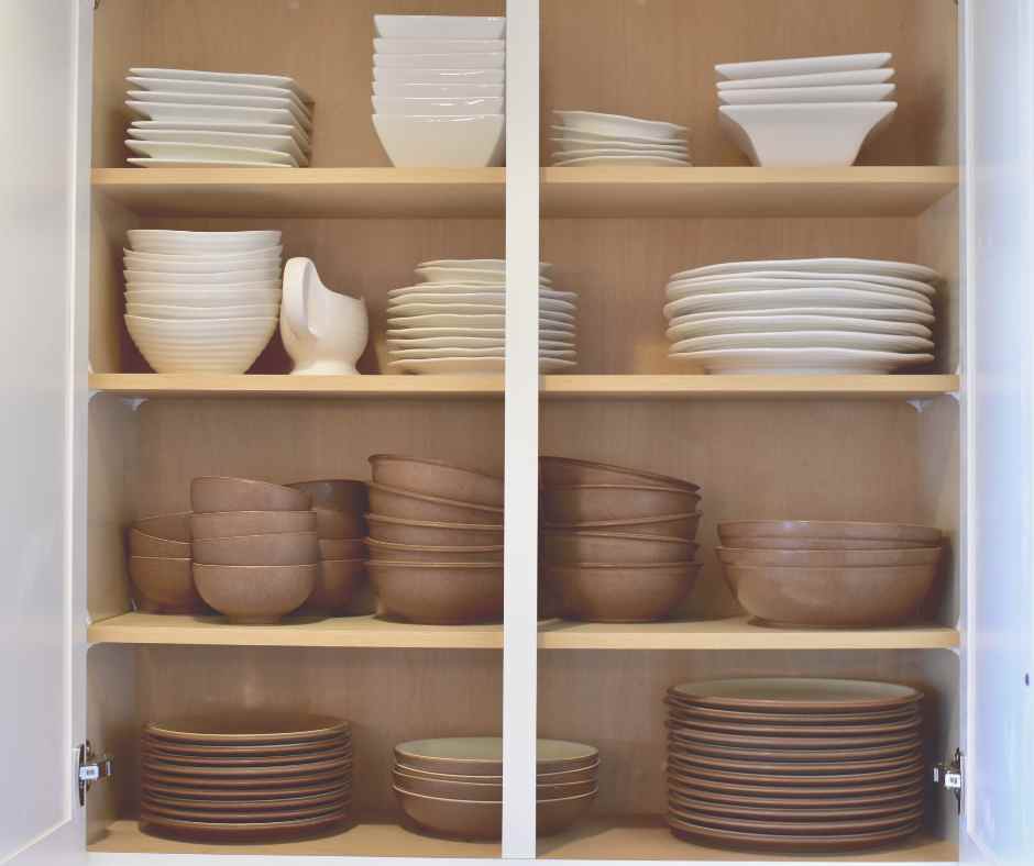 clean open kitchen cabinets with organized dishes