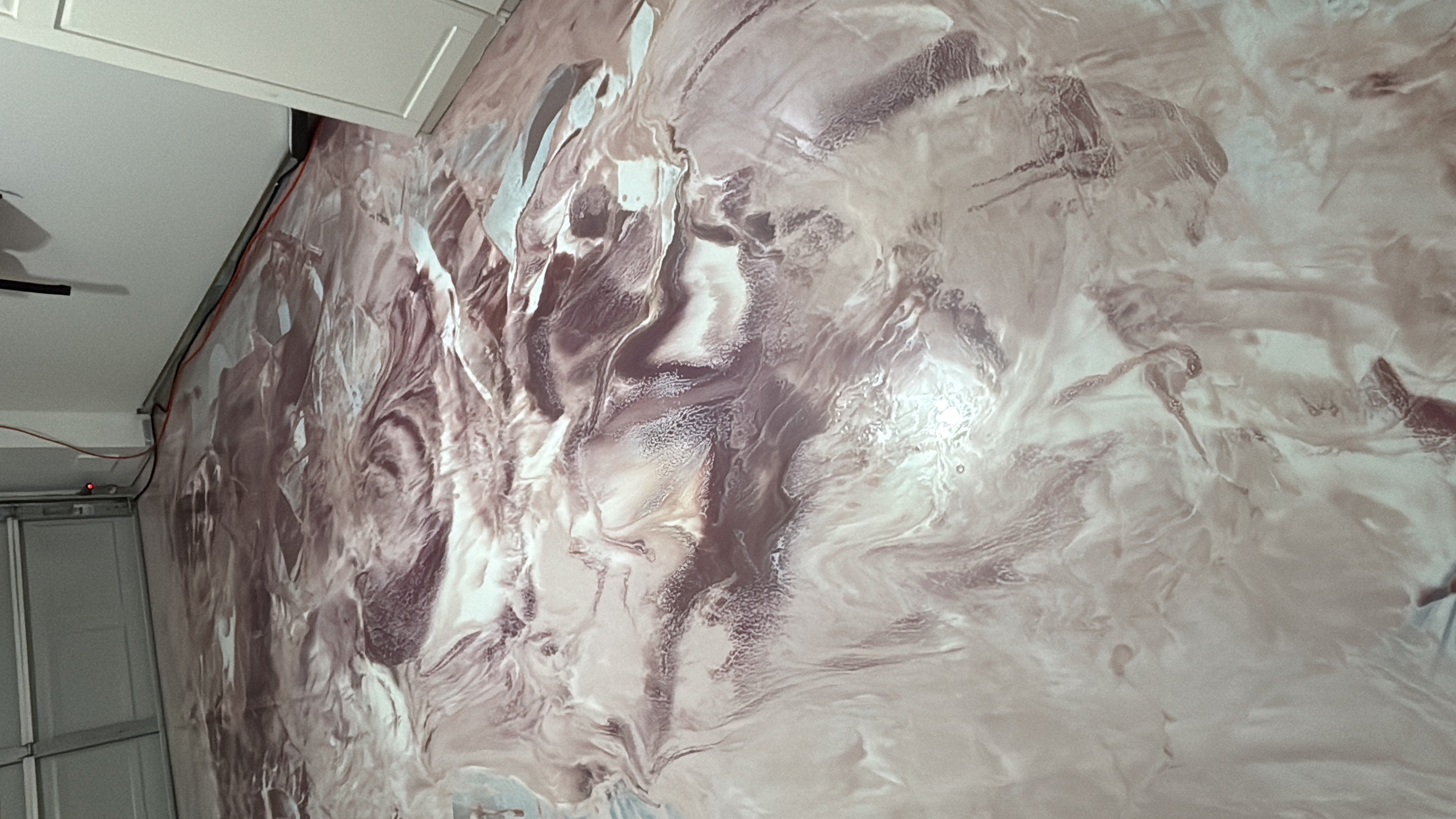 A white car in a garage with a finished floor