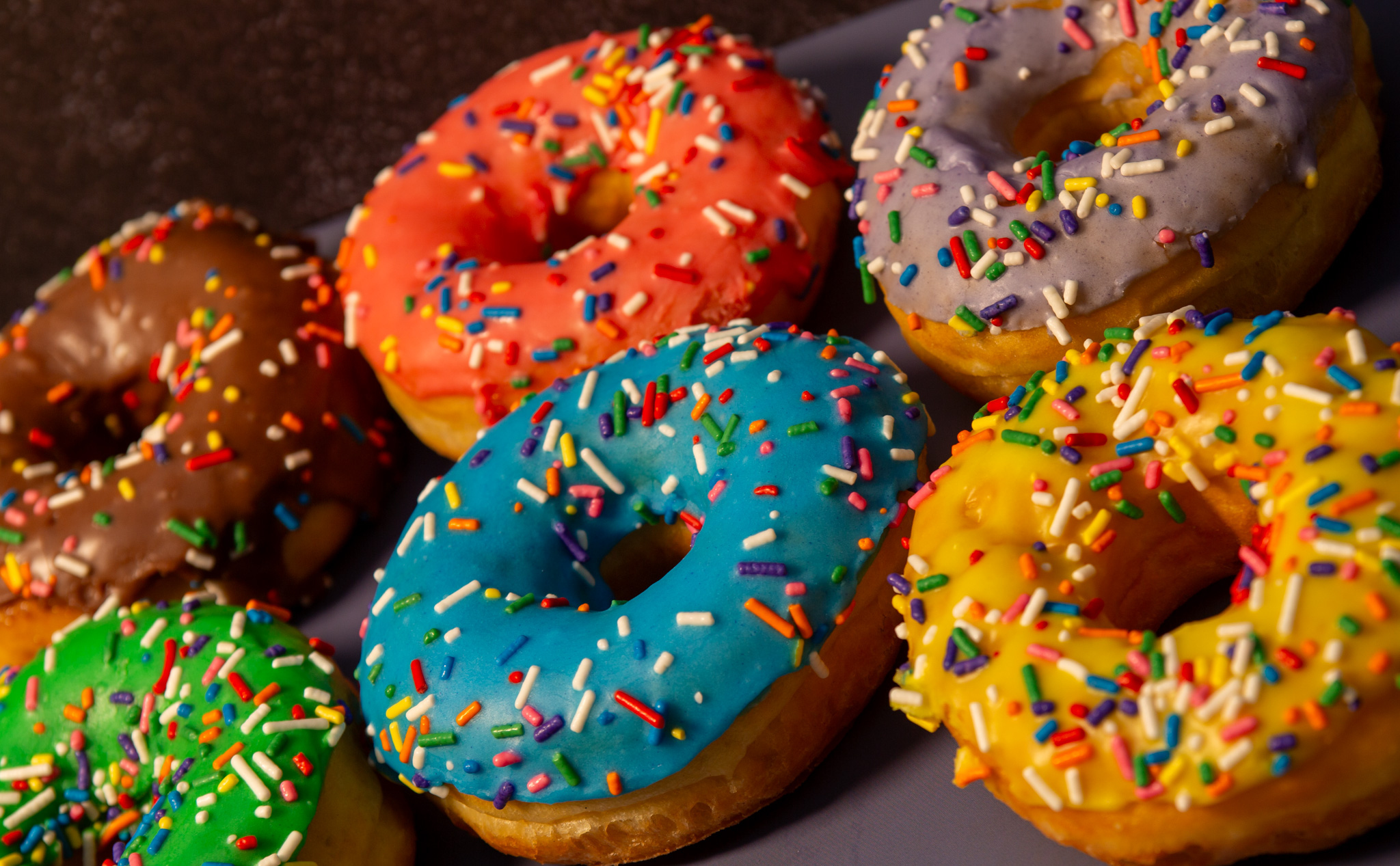 Fresh colorful sprinkle donuts at Doughman Donuts