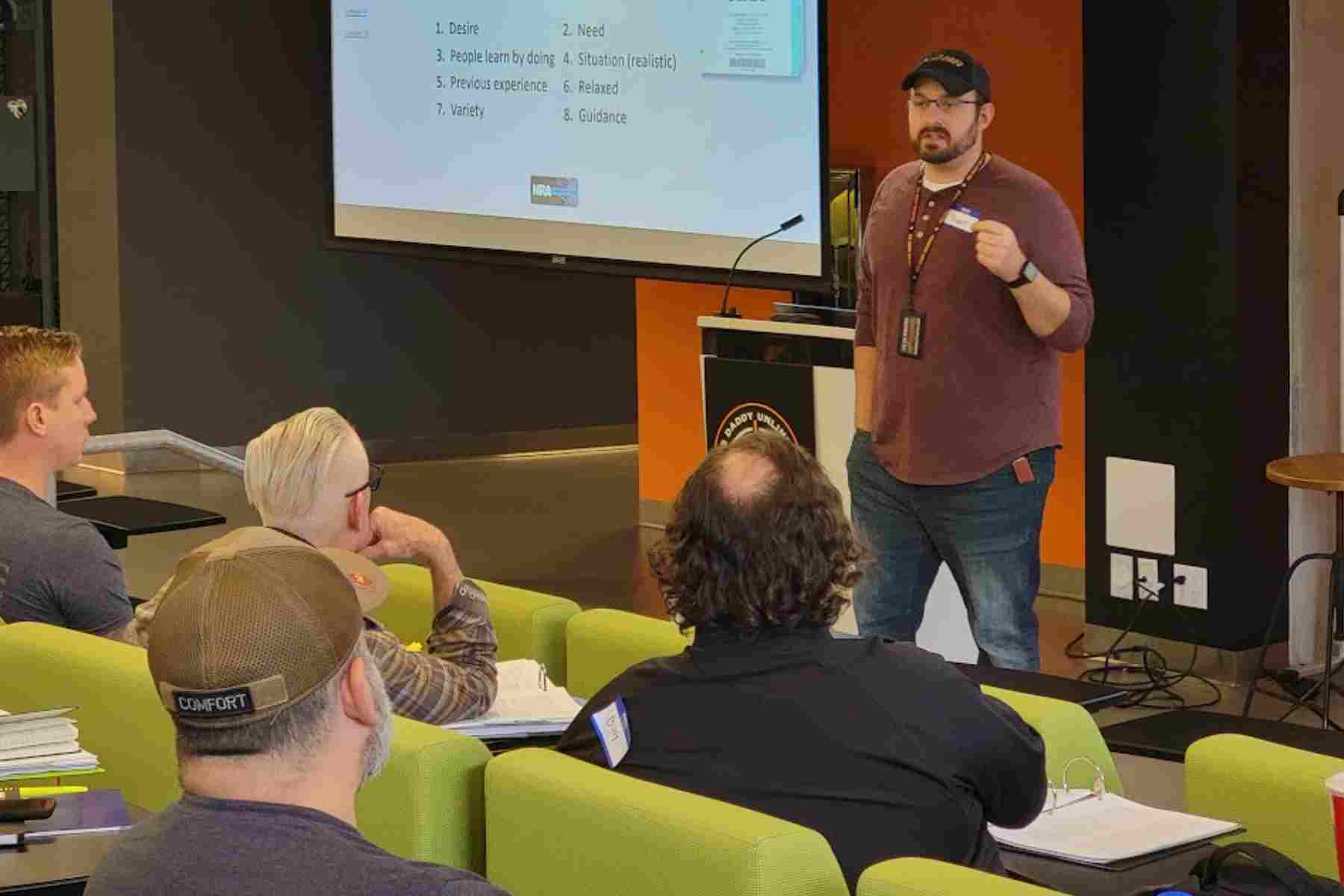 Professional firearm instructor leading a concealed carry class for adult students.