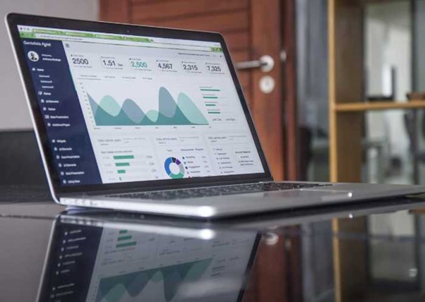 laptop computer on table showing google analytics for website traffic