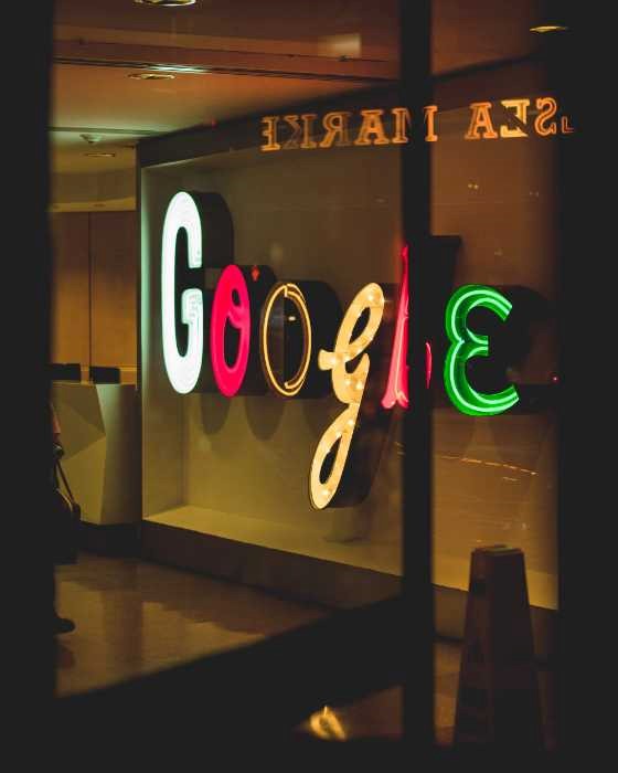 neon signed on glass windows spelling google