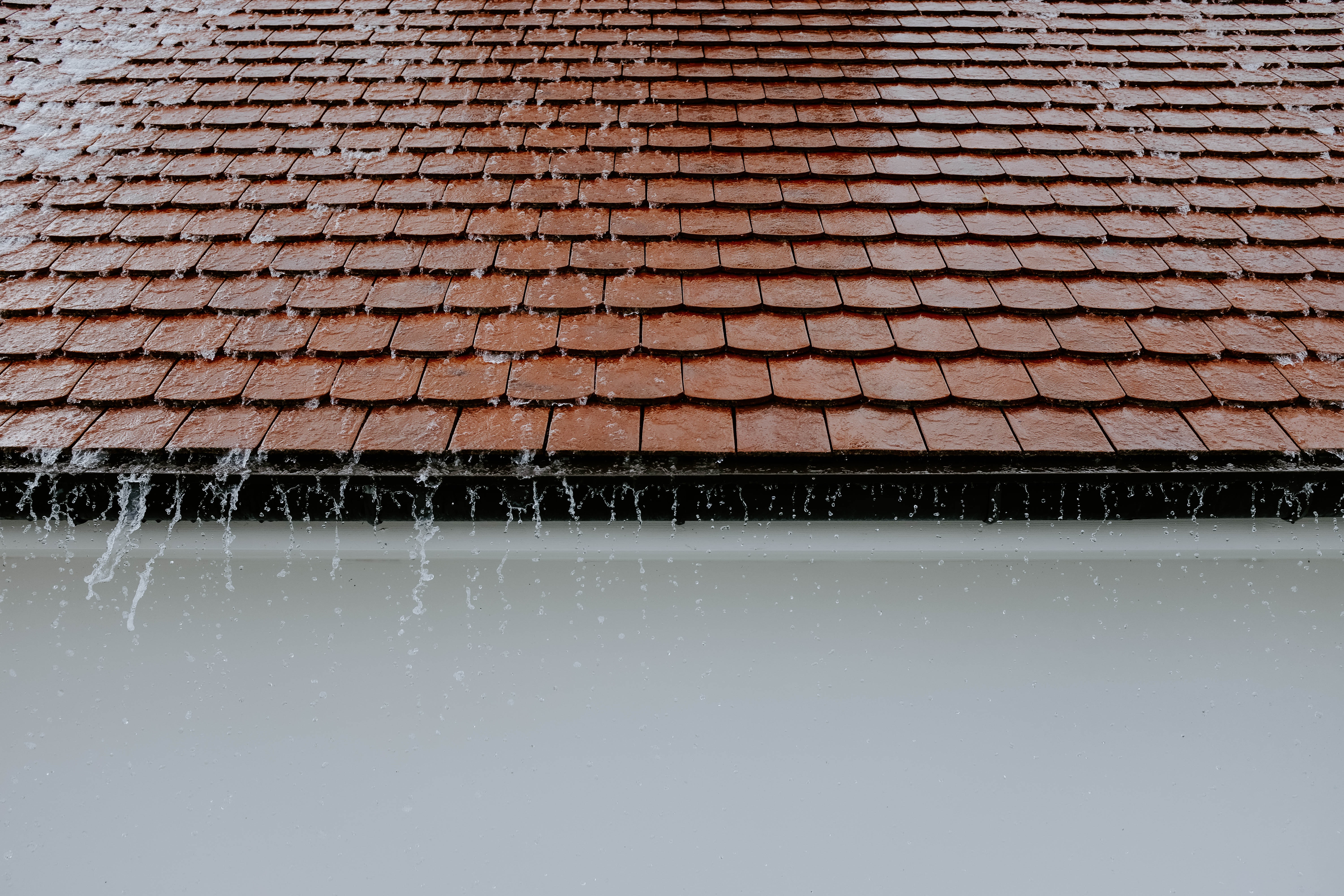 pouring rain on residential roofing - bad weather makes it hard to do roofing jobs