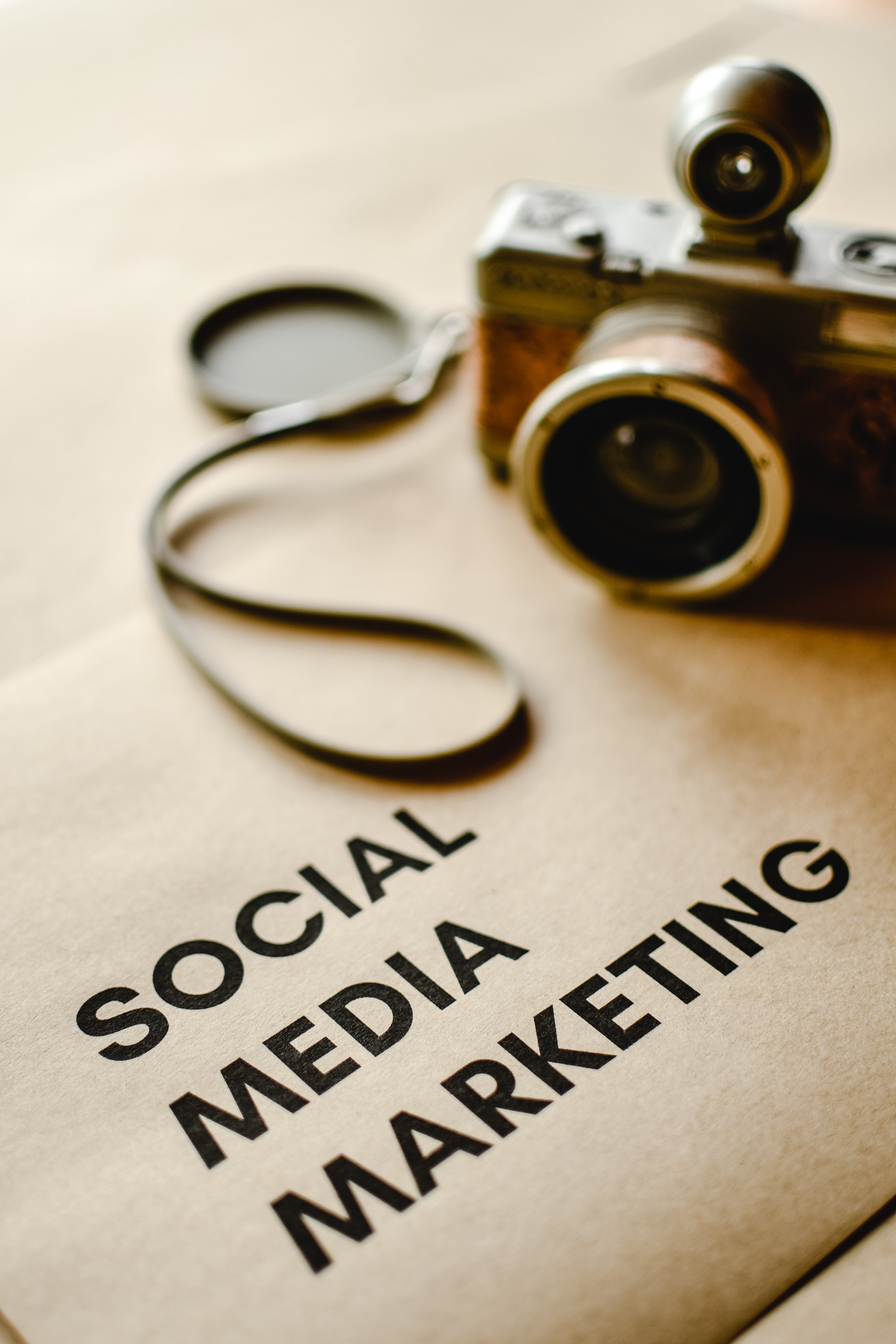 professional camera with social media marketing written on canvas