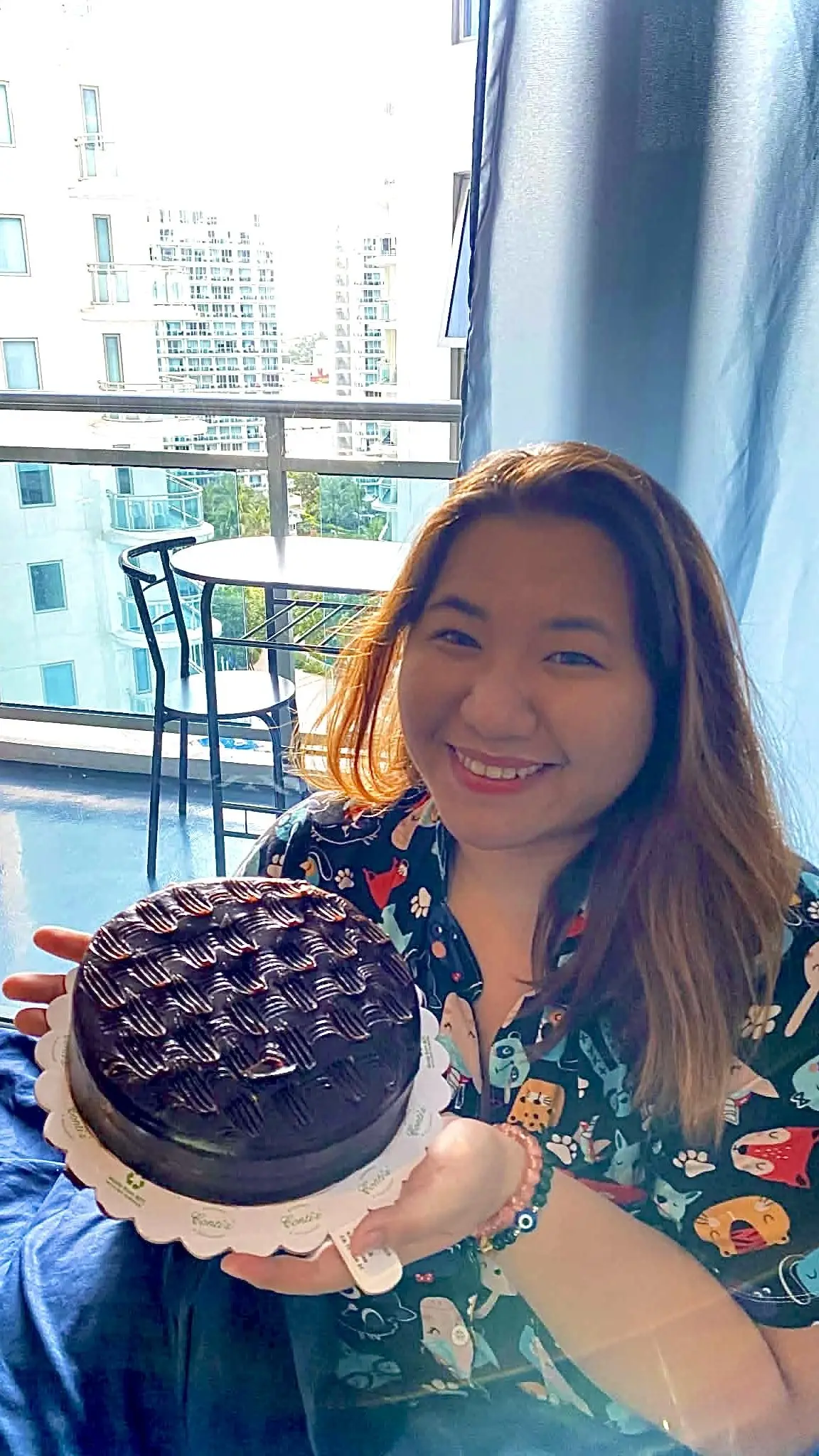 Jenny celebrating her birthday with a cake