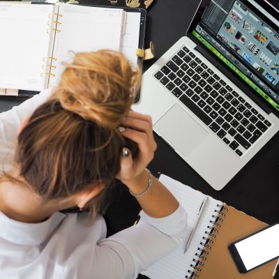 Tired woman looking at laptop
