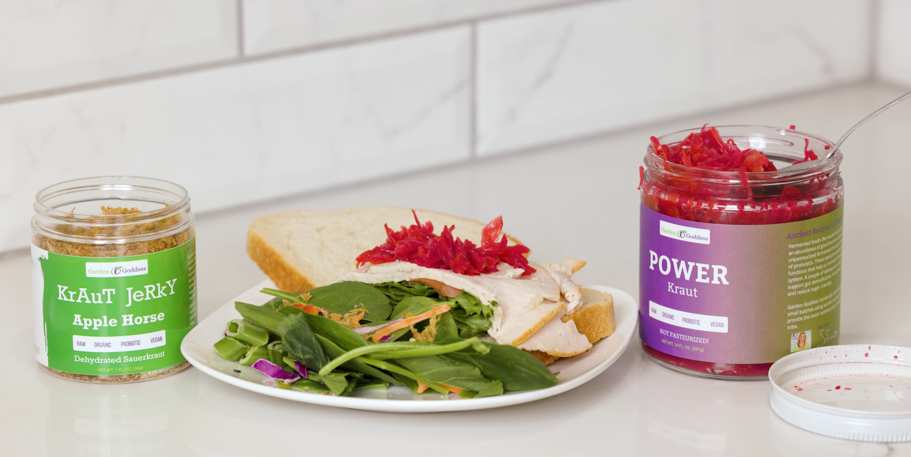 A salad with kraut jerky and a sandwich with garden goddess sauerkraut