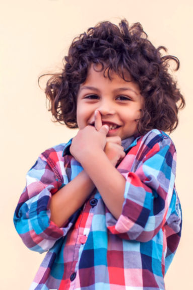 smiling little boy with long hair