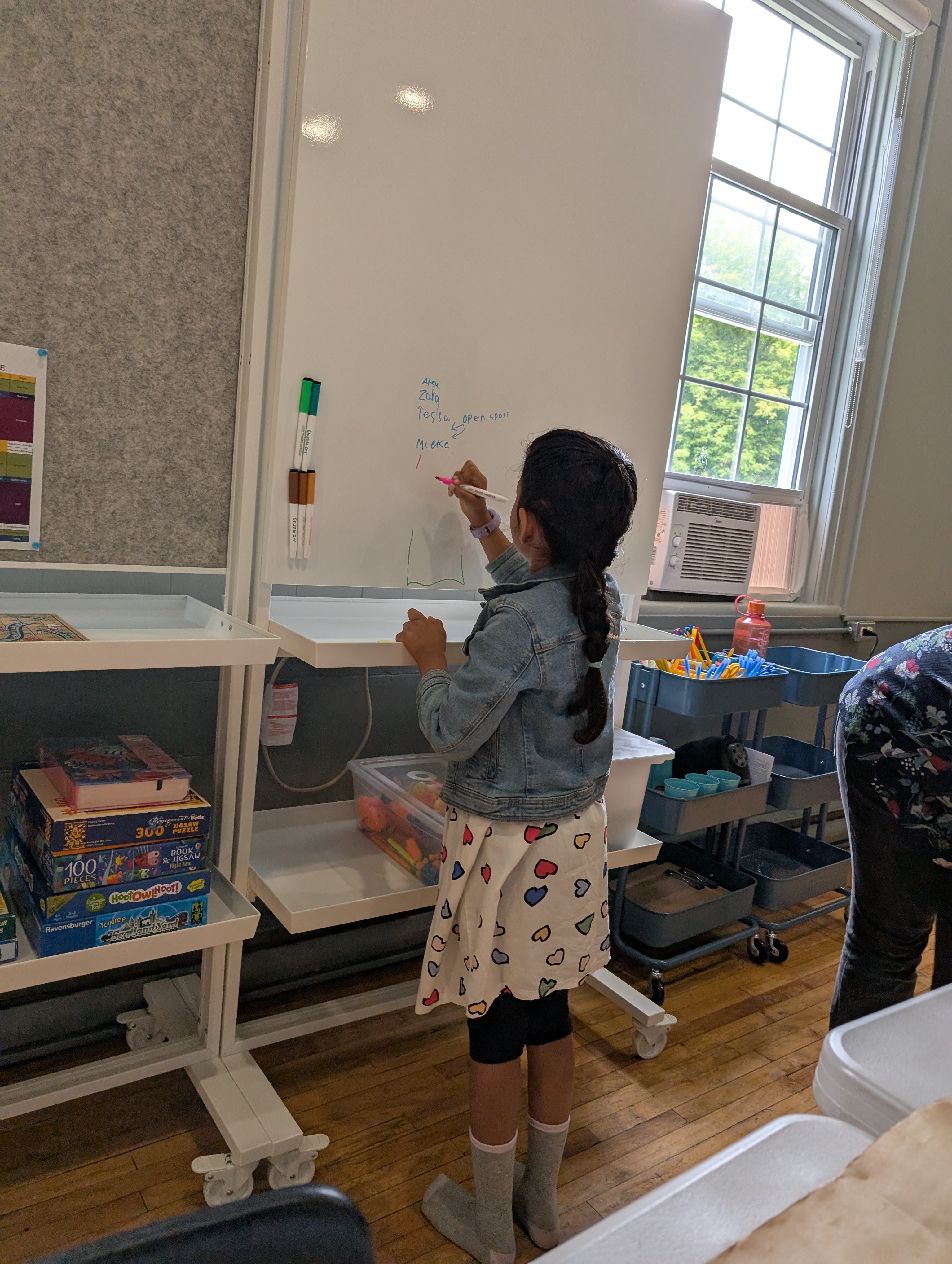 A learner writing on a whiteboard.