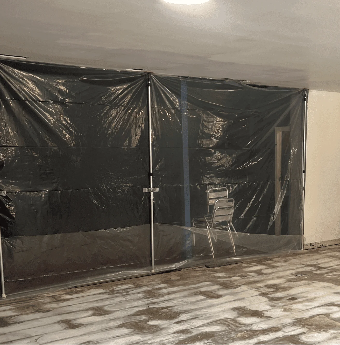 Plastic containment wall installed in the kitchenette area at Sydney Academy of Sport to isolate contaminated zones and control moisture during flood restoration. Plastic containment wall installed in the kitchenette area at Sydney Academy of Sport to isolate contaminated zones and control moisture during flood restoration.