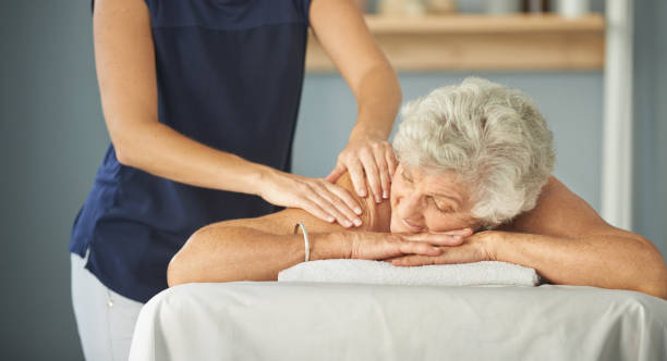 Maria providing gentle palliative care massage for seniors in a retirement home