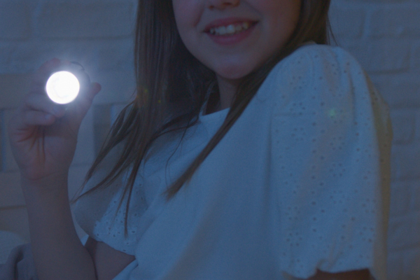 A smiling girl holding a flashlight in the dark, symbolizing hope, guidance, and support during the healing journey. A smiling girl holding a flashlight in the dark, symbolizing hope, guidance, and support during the healing journey.