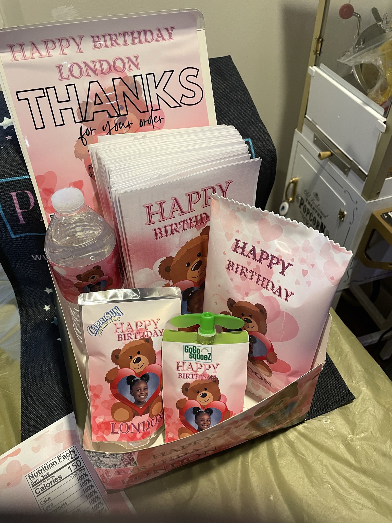 A collection of unique and colorful party favors including custom chip bags candy wrappers, personalized candles, and  