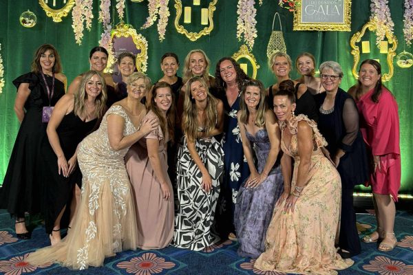 Claudette and her wellness team smiling together in formal gowns under a floral backdrop at the 2025 Amare Convention Gala Claudette and her wellness team smiling together in formal gowns under a floral backdrop at the 2025 Amare Convention Gala