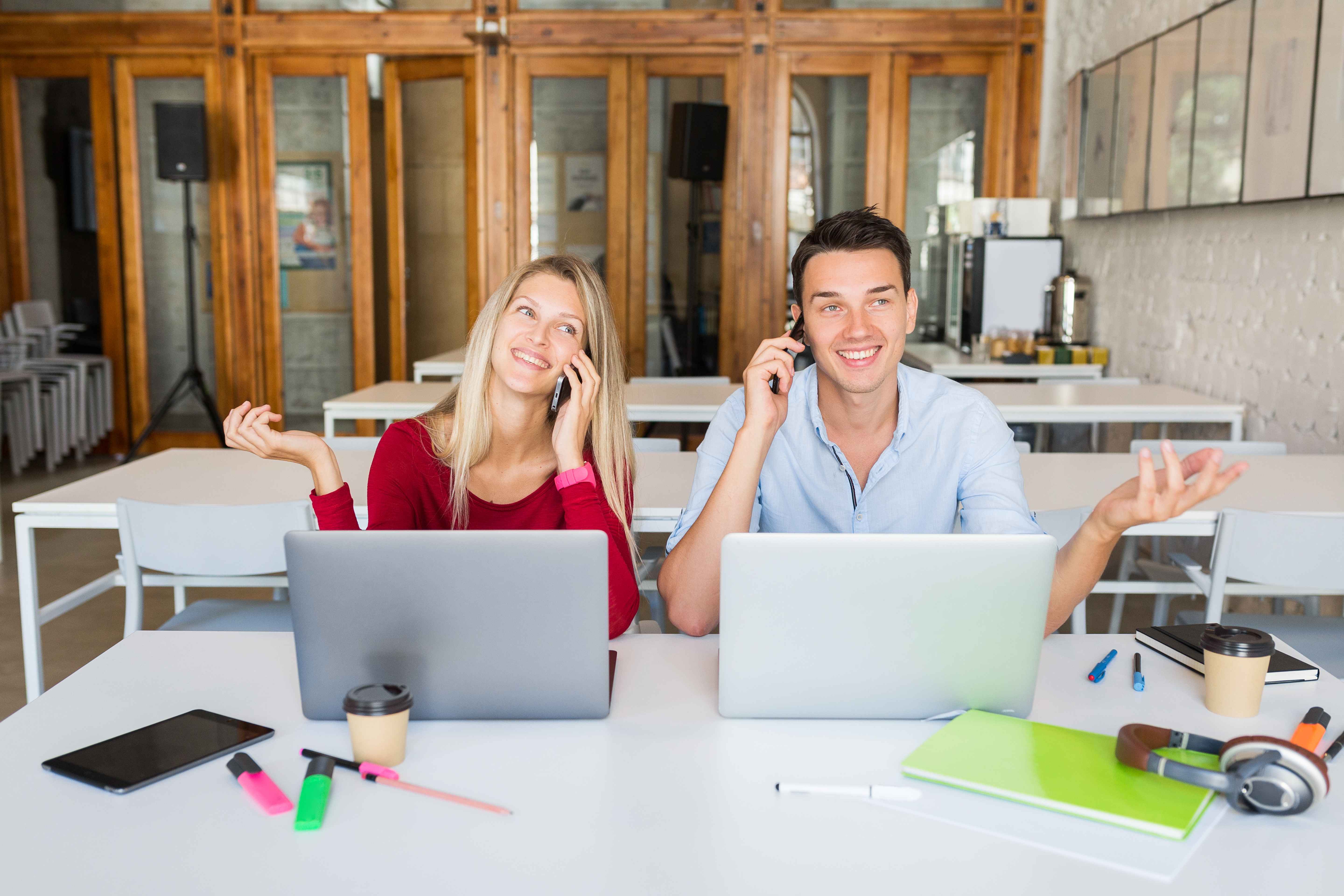 Two people talking with clients using their pay per call strategy Two people talking with clients using their pay per call strategy