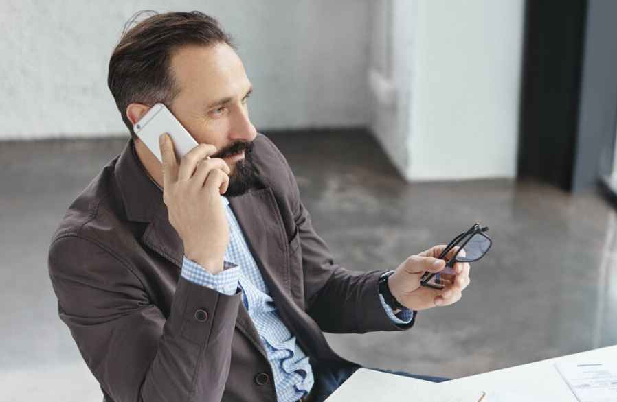 Local business owner on a phone call, using pay per call marketing to connect with clients. Local business owner on a phone call, using pay per call marketing to connect with clients.