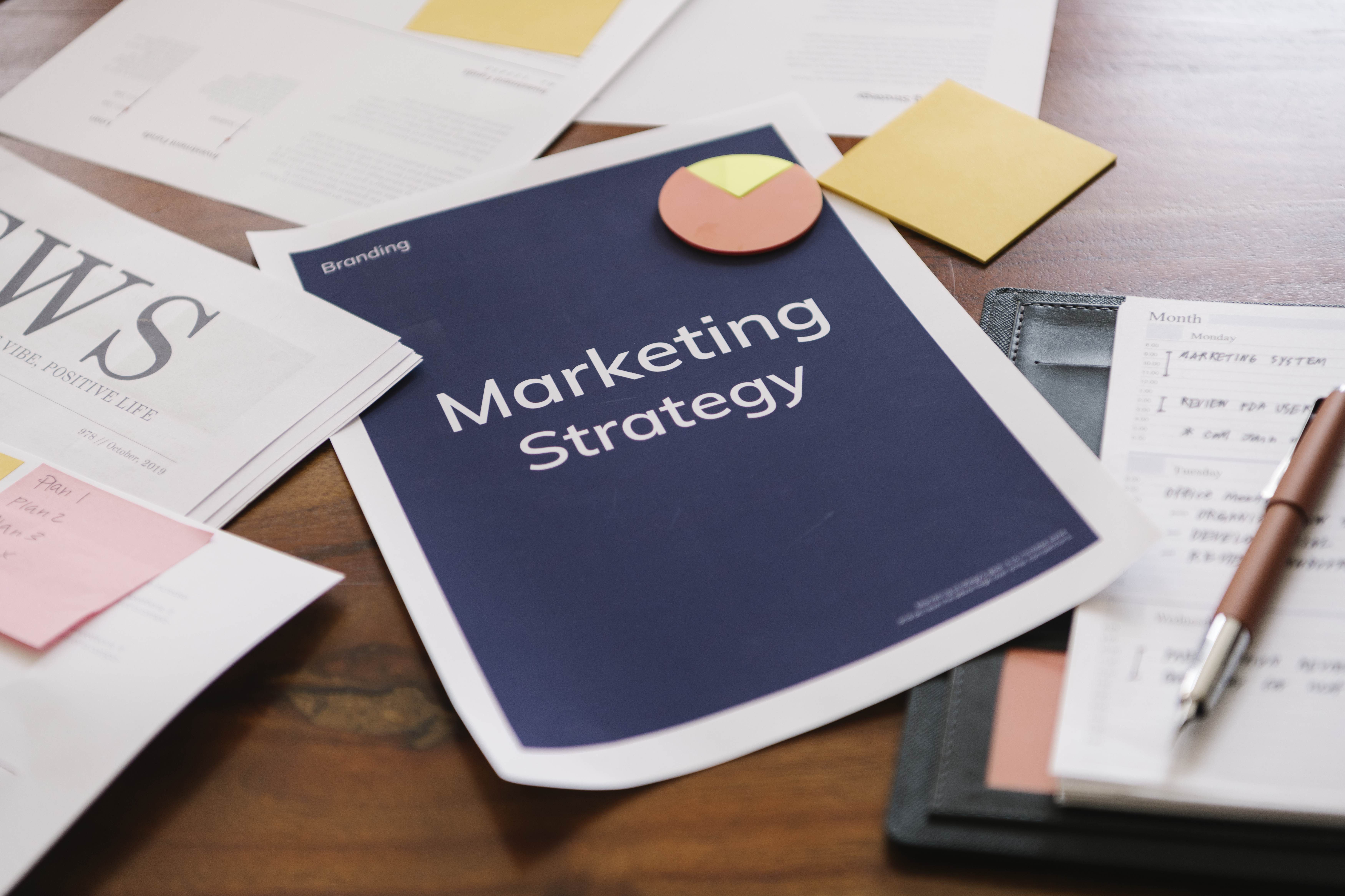 Marketing papers laid out on a table. Marketing Strategy and email list funnel strategy.