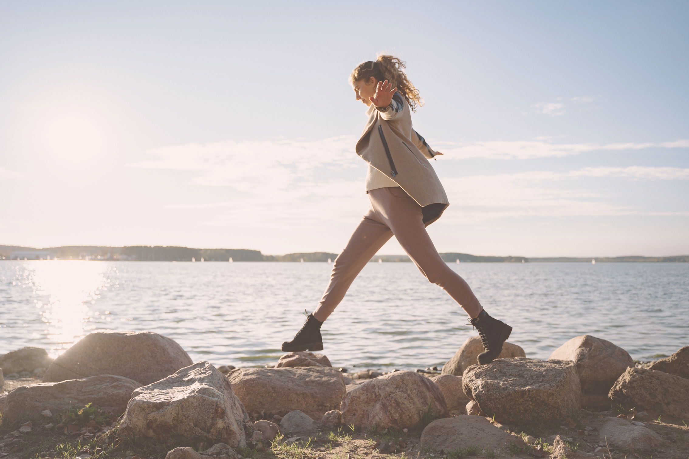woman stepping on stones