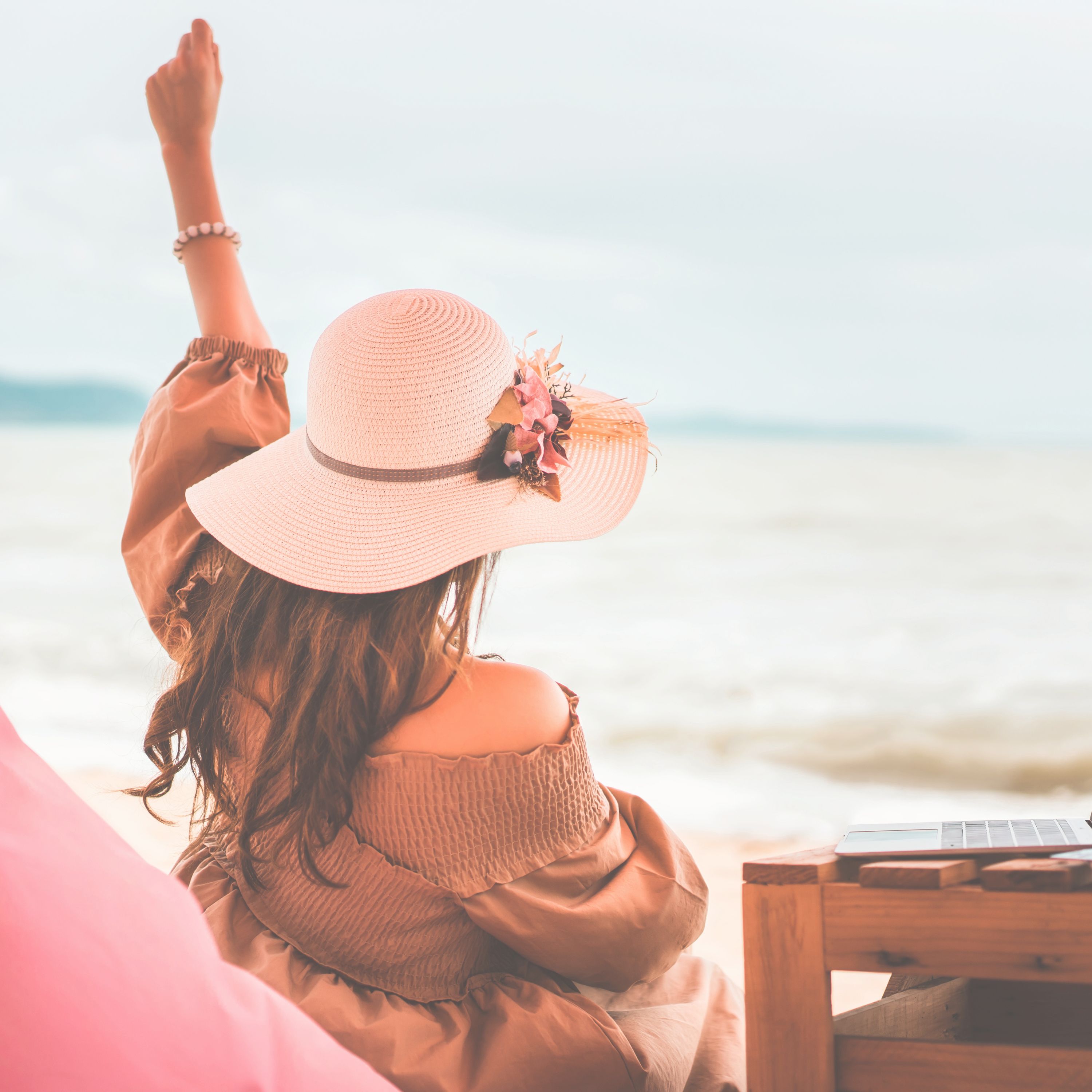 Woman sitting in the beach quietly celebrating Woman sitting in the beach quietly celebrating