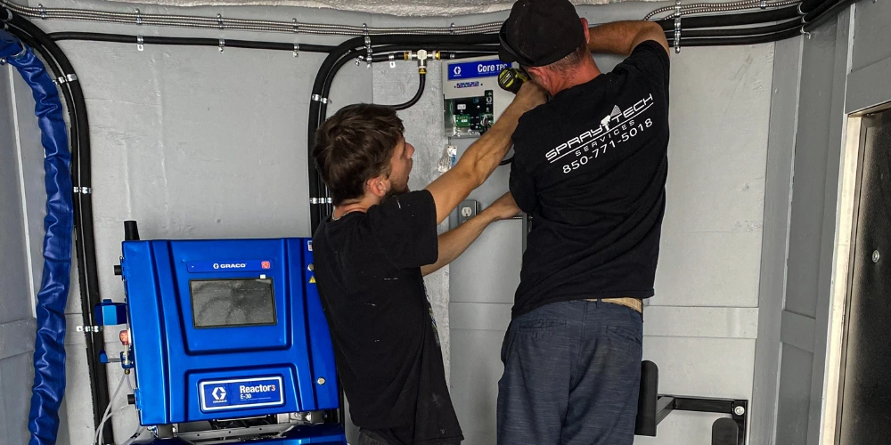 Two professional technicians working together on technical work