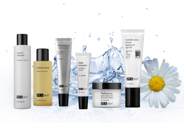 Six PCA Skin skincare products arranged in a row in front of a splash of water and a white daisy flower. The products include a creamy cleanser, nutrient toner, C&E advanced, ideal complex, ReBalance moisturizer, and hydrator plus broad spectrum SPF 30. Six PCA Skin skincare products arranged in a row in front of a splash of water and a white daisy flower. The products include a creamy cleanser, nutrient toner, C&E advanced, ideal complex, ReBalance moisturizer, and hydrator plus broad spectrum SPF 30.