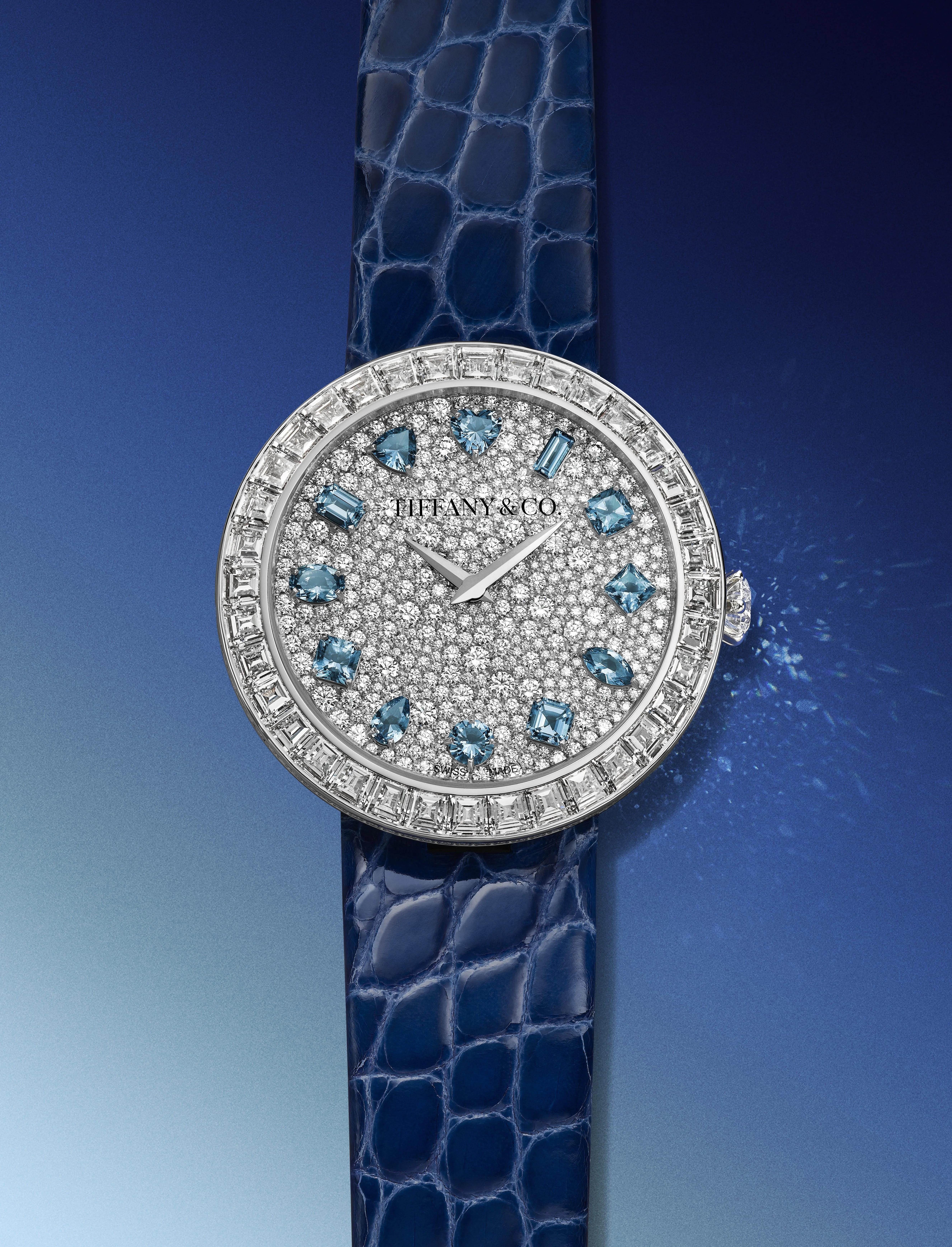 Detail of Tiffany & Co. Eternity Baguette watch snow-set diamond case, Tiffany Setting-inspired crown and blue alligator strap