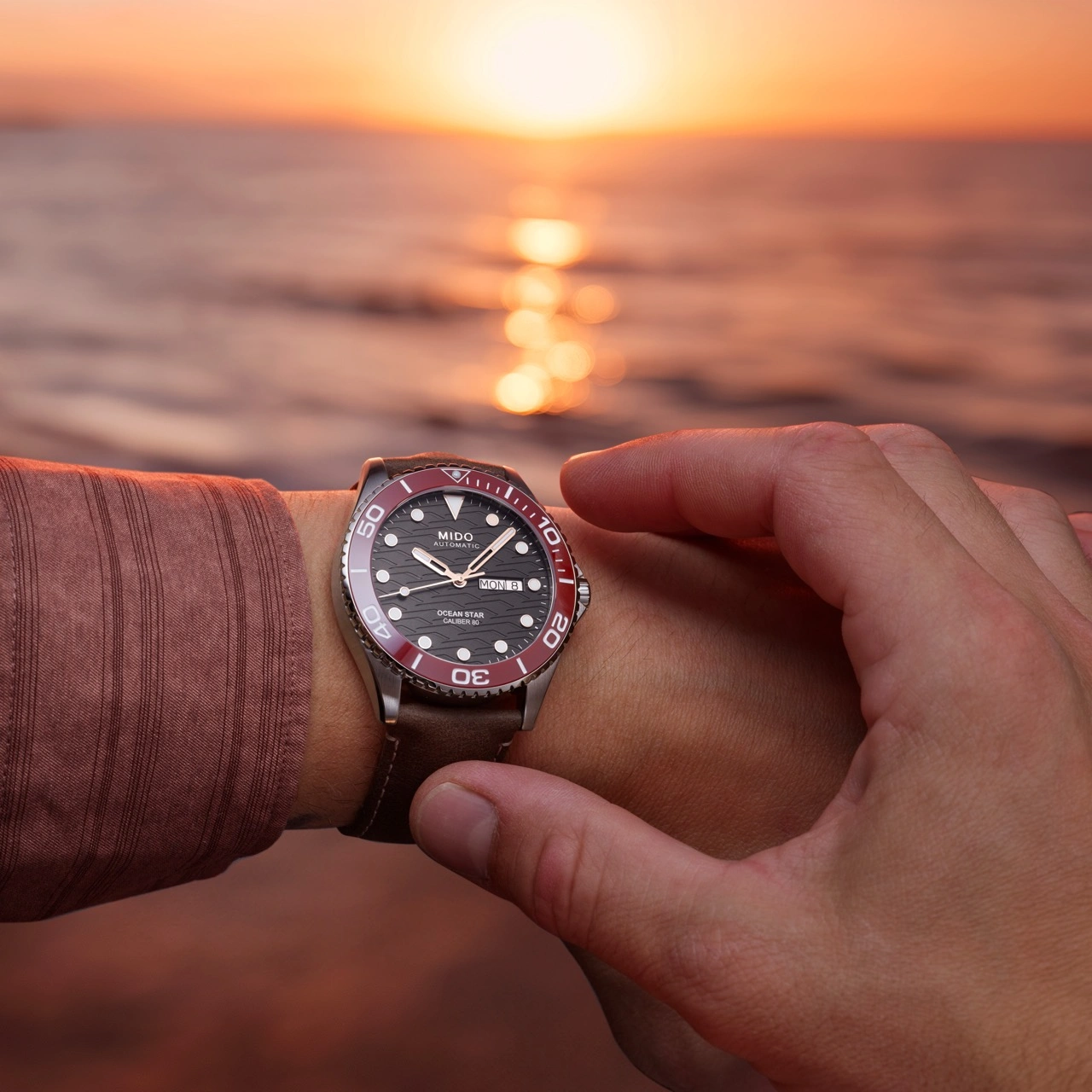 Dial close-up of the MIDO Ocean Star 200C with wave motif and rose gold accents