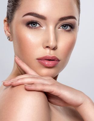 Woman with flawless, radiant skin and sculpted features — showcasing results of non-surgical facial rejuvenation and dermal fillers at One8Clinic in Johannesburg.