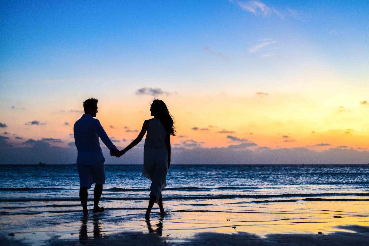 couple holding hands on beach couple holding hands on beach