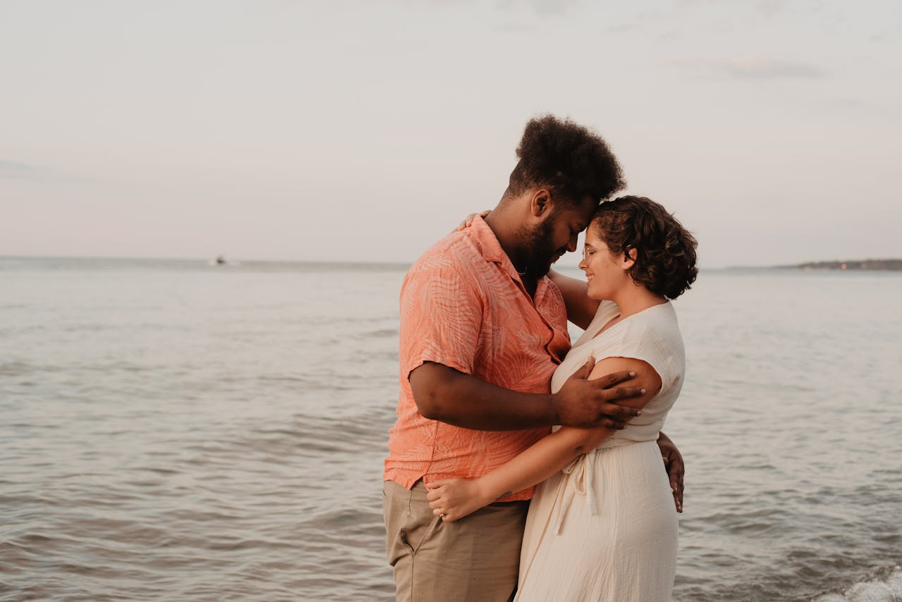 couple hugging by water