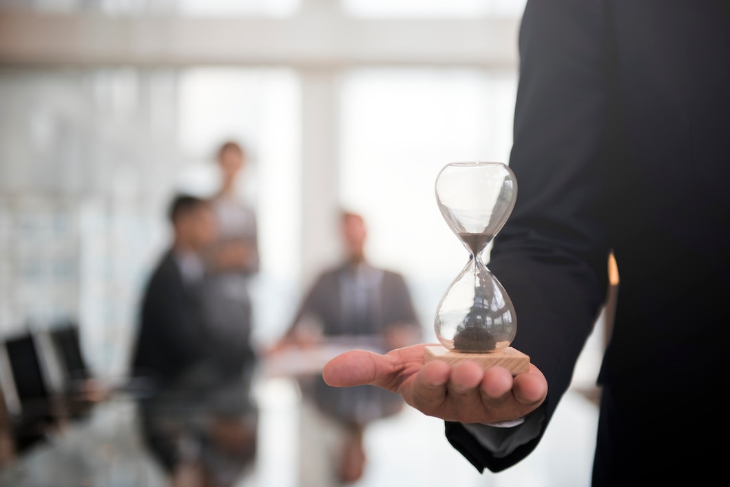Businessman holding an hour glass