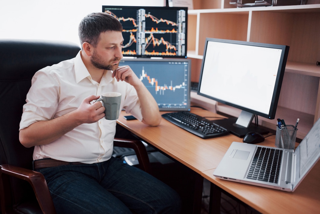 Young businessman is sitting in office at table