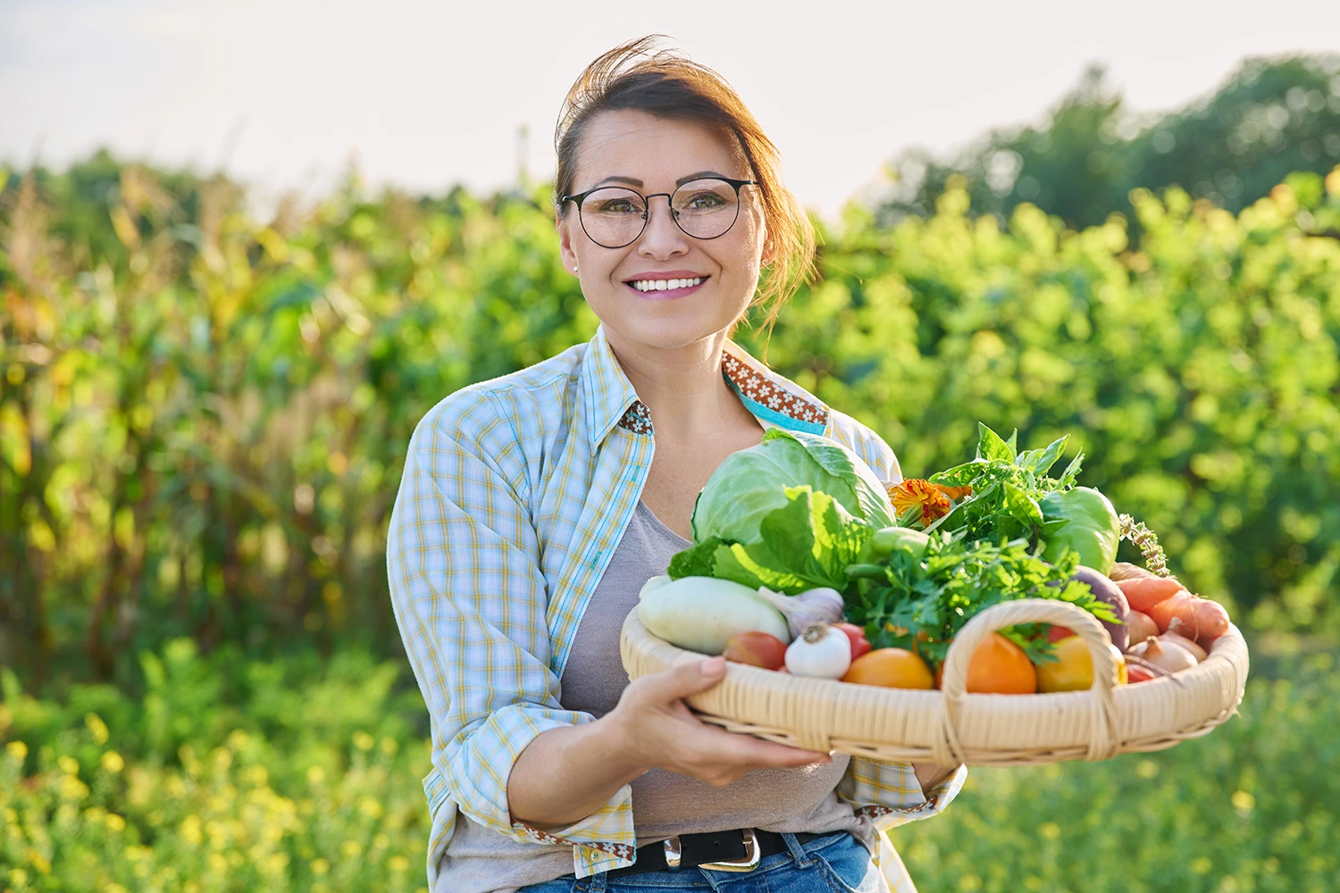 a woman holding fresh vegetables