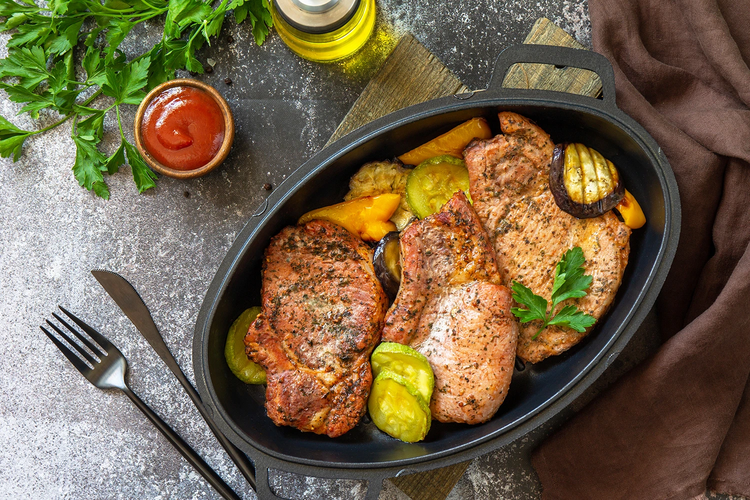 A clean, appetizing shot of grilled lean pork tenderloin slices with colorful vegetables on the side