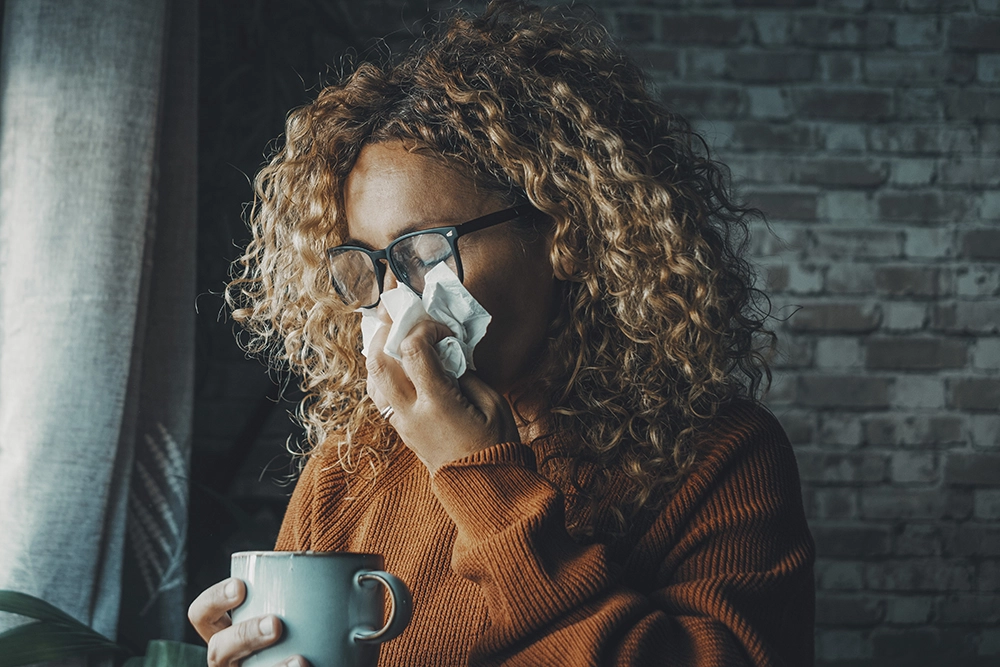 One woman sneezing nose with allergies