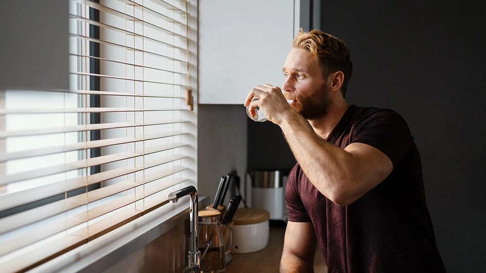 A man drinking water from a glass