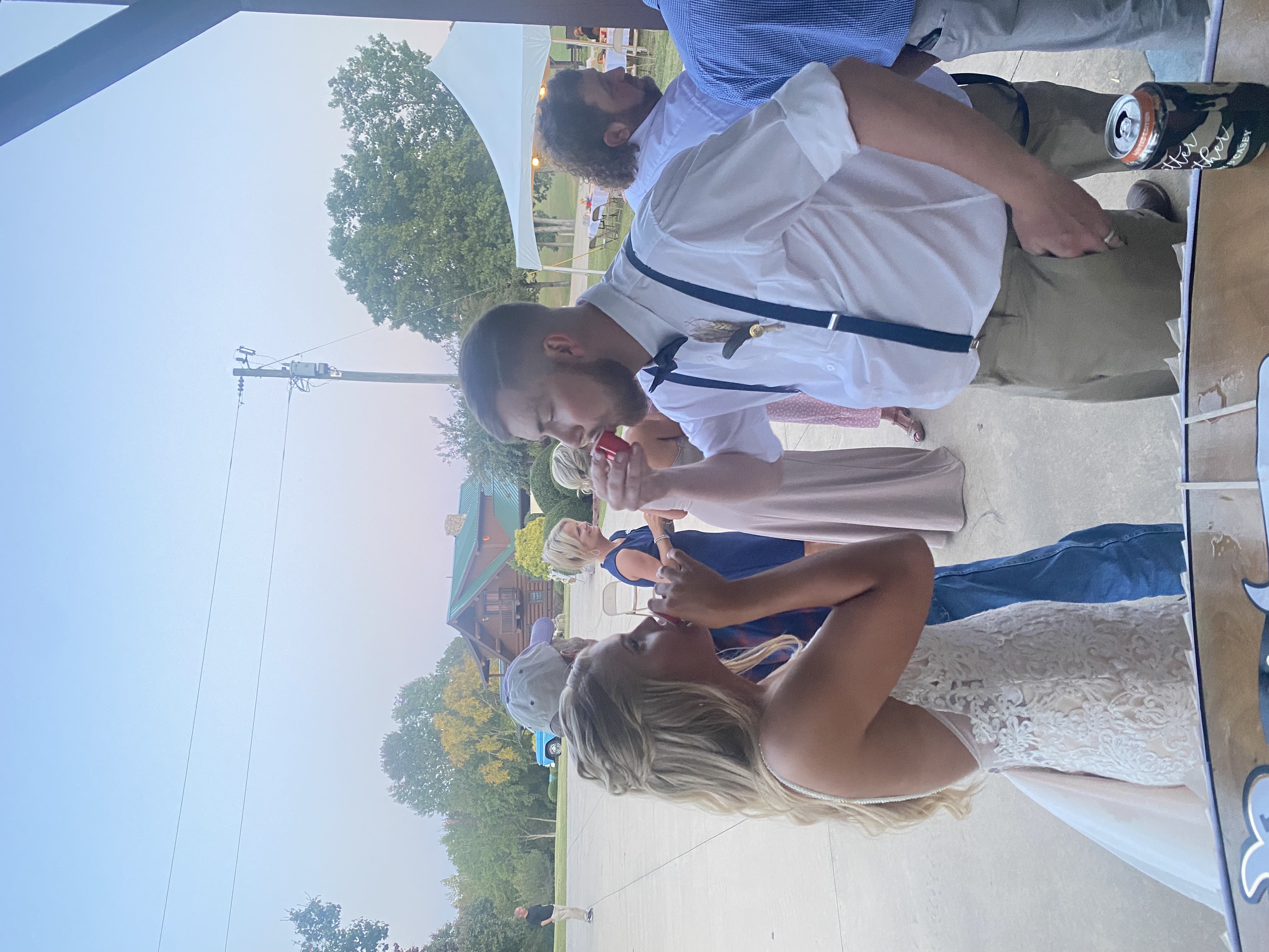 Wedding reception bar with signature cocktails and guests celebrating